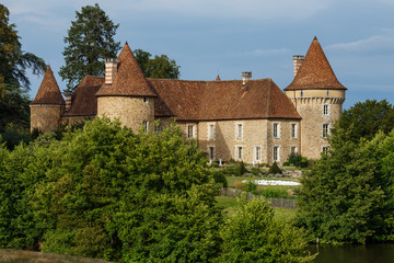 Fototapeta na wymiar Medieval french chateau surrounded beautiful garden and greenery. Old castle made from stones in France. Traditional architecture of bordeaux wine region. Summer landscape