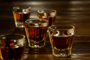whiskey in shots on a wooden table, alcoholic beverages drinks