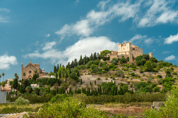 ancient castle on a hill on a background of blue sky, and below the ancient church