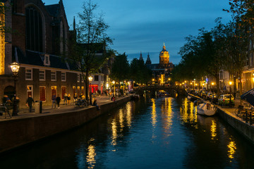 Fototapeta na wymiar Amsterdam canal evening view with houses and illumination