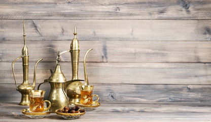 Fototapeta na wymiar Tea table dates golden oriental decoration wooden background