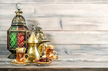 Fototapeta na wymiar Tea glasses oriental lantern decoration wooden background