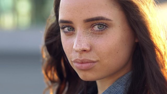 Portrait of attractive woman with a scnanning grid on her face. Face id, security, facial recognition concept.