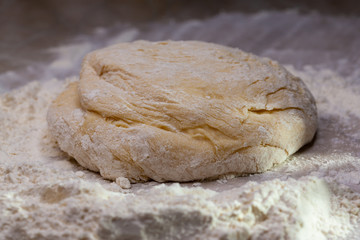 Dough in flour on the table