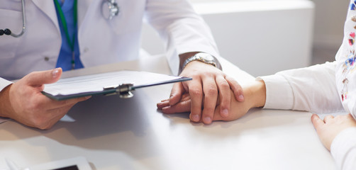 close up of patient and doctor prescribing medication