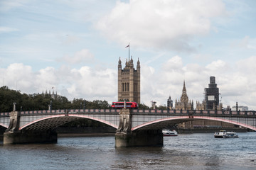 Fototapeta na wymiar red double decker bus going over bridge in front of london tower