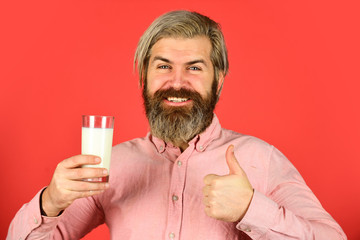 Vegan milk concept. Bearded man hold glass of milk. Pasteurized milk. Vegan milks made from wide variety of beans nut, seeds and grains. Drink protein cocktail. Healthy habits. Lactose free