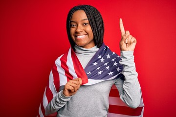 Young african american patriotic woman wearing united states of america flag on independence day...