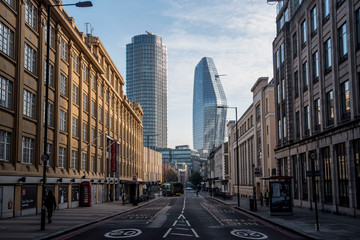 tall skyscrapers down empty street in london - obrazy, fototapety, plakaty