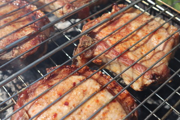 Pork steaks cooked on a charcoal grill outdoors