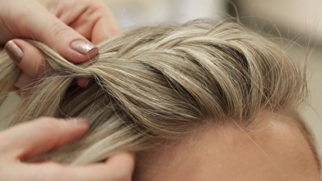 Hair stylist braiding hair
