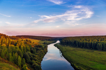 river and forest from a high hill at sunset