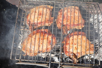 Pork steaks cooked on a charcoal grill outdoors