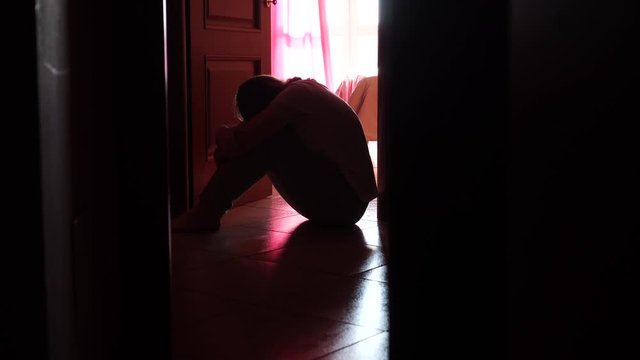 Girl in the Darkness in Depression, Mental Problems, Abuse, Domestic Violence. Self Isolation Concept