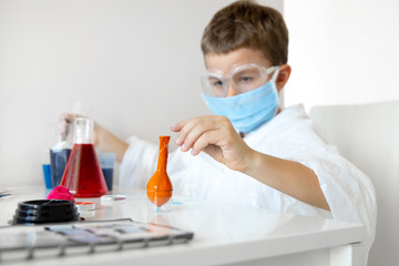 Smart little kid studing with home laboratory