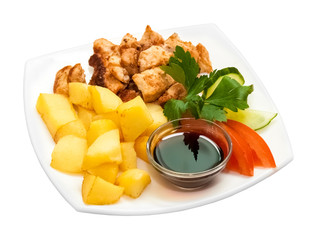 Chicken skewers with fried potatoes and fresh vegetables on a white background. Isolated object
