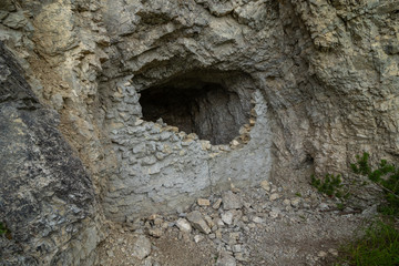 Demolished entrance to a small cave in the Dolomites