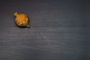 old spinning top on dark wooden table