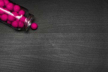 Colorful balls on dark wooden table