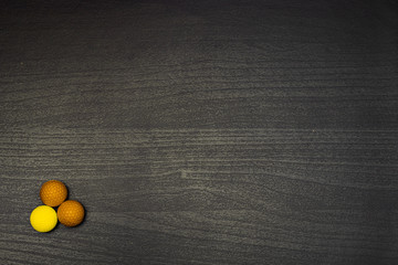 Colorful balls on dark wooden table © Simão Moreira