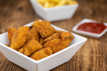 Vintage wooden table with fresh made Chicken Nuggets