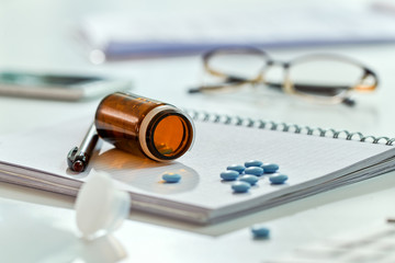 Pill bottle and medicines on the table.