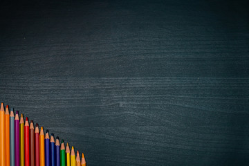 colored pencils on black wooden table