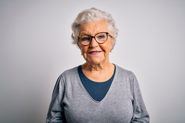 Senior beautiful grey-haired woman wearing casual sweater and glasses over white background with a...