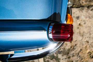 Taillight of a classic blue Triumph Spitfire Mark III 1967