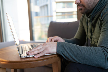 man working online at home or study using laptop on sofa. Stay home quarantine, Remote working.