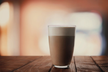 A glass of fresh cappuccino on the table