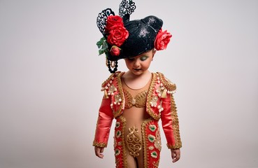 Young little caucasian kid girl wearing  bullfighter traditional folkore spanish suit as carnival...