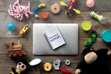 A laptop surrounded by children's toys.