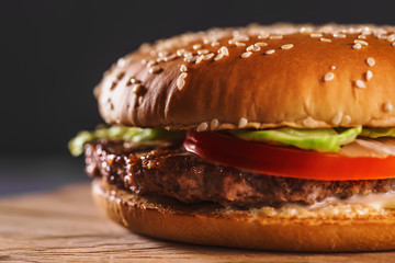 Fresh homemade burger or hamburger, fast food, macro photo, copy space.