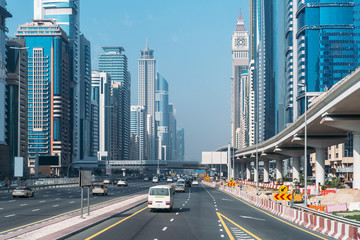 Sheikh Zayed Road in Dubai downtown with car traffic and high buildings.