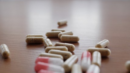 Packaging of tablets and pills on the table. Selective focus on pills, tablets, vitamins, drugs, capsules, medicament and food supplement for health care. Medicine. Pharmaceutical industry. 