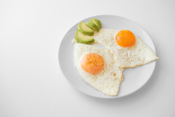 Scrambled eggs with avocado and specialy on a white plate on a white background with blank copy space, top view