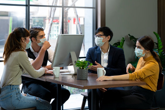 Businessman And Women Working Together In Public Places On A Day That Covid 19 Virus Are Epidemics. They Wear Surgical Masks To Prevent The Outbreak Of Corona Virus, Influenza Or Dust Allergy.