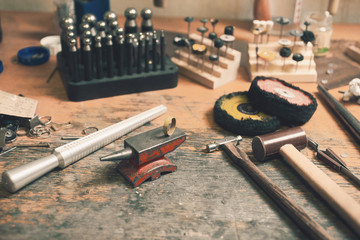 Different goldsmiths tools on the goldsmith workplace. background - obrazy, fototapety, plakaty