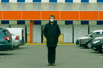 lonely man in mask overcrowded parking social isolation dangerous conditions in quarantine time...