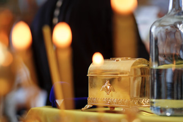 Russian eastern orthodox church golden box in a candle lights.