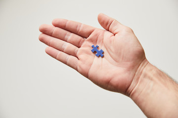 Hand with blue puzzle piece
