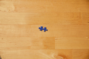 blue puzzle piece on wooden background
