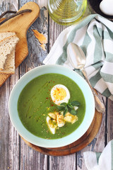 Green pea soup with spinach, olive oil, sesame and half boiled egg
