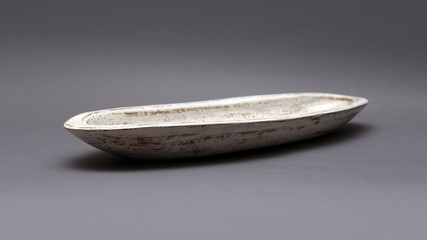 Decorative white and brown oval bowl isolated on neutral background