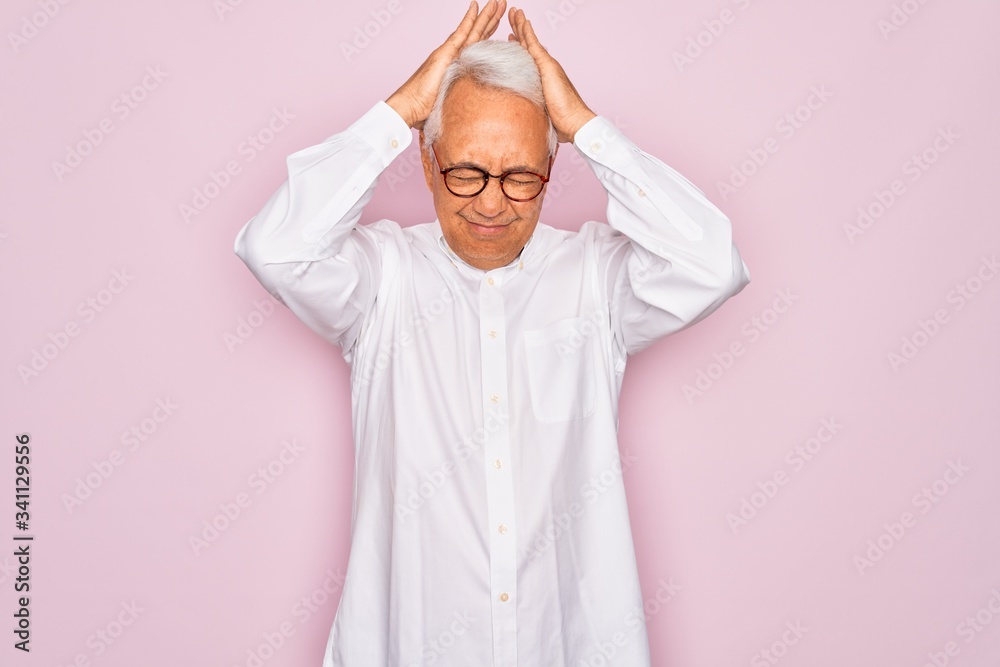 Sticker Middle age senior grey-haired man wearing glasses and business shirt over pink background suffering from headache desperate and stressed because pain and migraine. Hands on head.