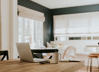 Laptop on a dining room table