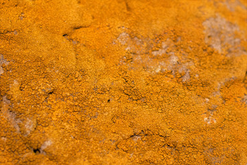 Unevenly cracked terracotta texture with a rich orange tint. Photo trending texture for your design.