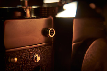 Close ups of details a vintage russian 35mm film camera Zenit TTL laying on a wooden desk.