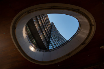Obraz premium Milan, Italy, March 2020. Window in the window with a view of the multi-storey building. Window color dark wood. Milan 01.20